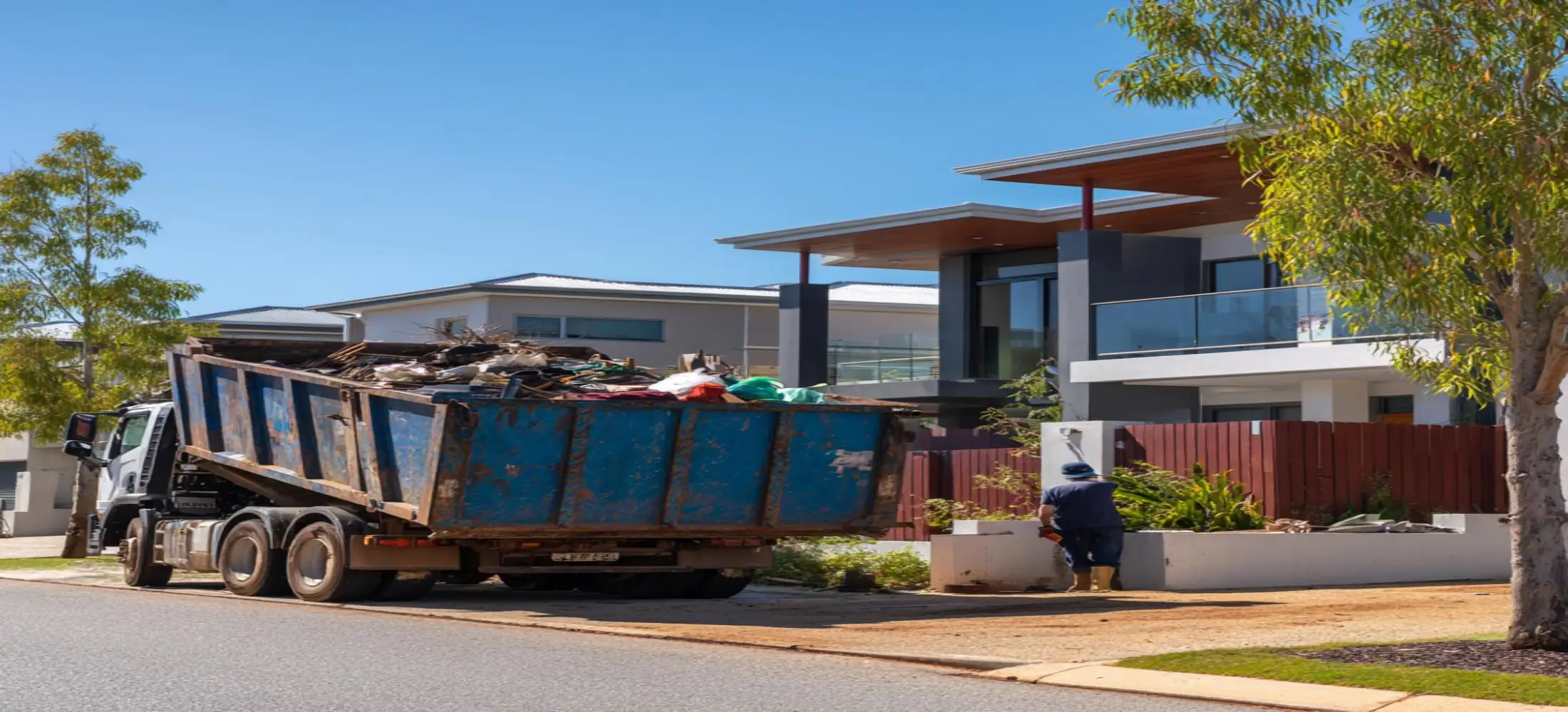 Large skip bin outside a residential property with mixed rubbish and renovation debris during a skip bin Bunbury waste removal project